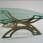 Custom glass top coffee table carved and painted. Powder coated steel base.