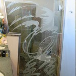 Custom carved and tempered shower door.