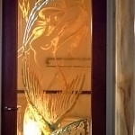 Custom carved, tempered and painted glass doors.